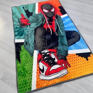 May include: A colorful rug featuring a cartoon superhero wearing a red and black suit and sneakers. The rug has a comic book style design with a blue, green, orange, and yellow background.