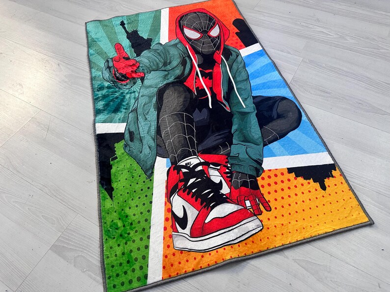 May include: A colorful rug featuring a cartoon superhero wearing a red and black suit and sneakers. The rug has a comic book style design with a blue, green, orange, and yellow background.