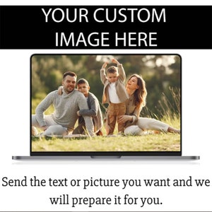 May include: A laptop computer screen displaying a photo of a family of four sitting in a grassy field. The family is smiling and appears to be enjoying their time together.