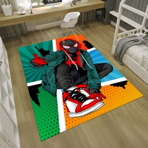 May include: A colorful rug featuring a cartoon illustration of Spider-Man in a red and black suit, sitting with his legs crossed. The background is a comic book style design with red, blue, green, and yellow colors.