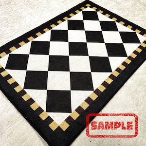 May include: Black and white checkered rug with a tan border. The rug has a diamond pattern and is made of a soft, durable material. The rug is perfect for adding a touch of style to any room.