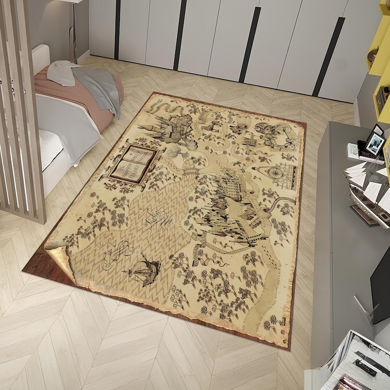 May include: A rectangular area rug with a vintage map design. The rug features a beige background with brown illustrations of a map, including a book, trees, and a ship. The rug has a brown border and is placed on a light wood floor.