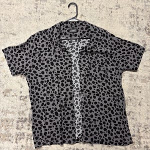 May include: A rustic wooden sign with the text "Welcome to our home" in white lettering. The sign features a distressed finish and a simple, inviting design, perfect for a front porch or entryway.