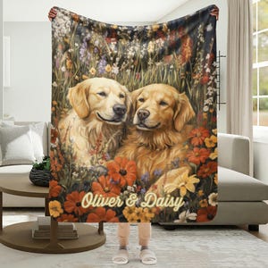 May include: A plush blanket featuring a detailed illustration of two Golden Retrievers amidst a vibrant floral meadow. The blanket showcases the dogs' faces and the text "Oliver & Daisy" in a decorative font, with a warm color palette.