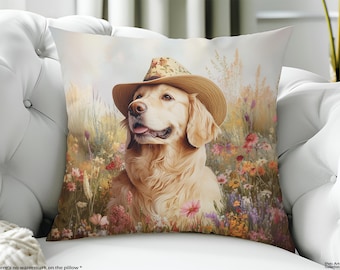 May include: A square throw pillow featuring a golden retriever wearing a tan straw hat with a floral band. The dog is positioned in a field of colorful wildflowers and tall grasses, rendered in a soft, painterly style with warm, light tones.