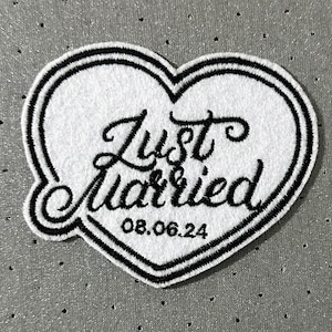 May include: White heart-shaped patch with black embroidered text that reads "Just Married" and the date "08.06.24".