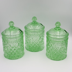 May include: A set of three ceramic mugs with a speckled, matte finish. The mugs are in shades of cream, light gray, and dark gray. Each mug has a simple, minimalist design, perfect for coffee or tea.