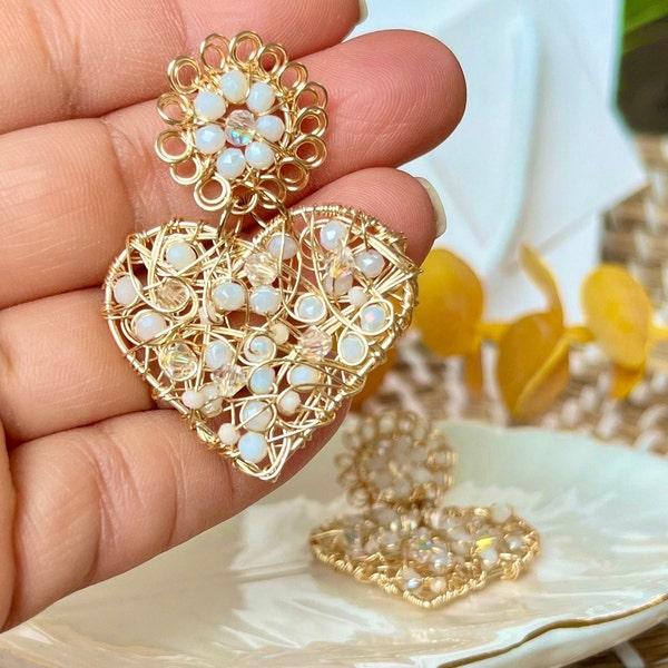 Beautiful long earrings in the shape of a heart and small flower. Earrings. Gold plated wire earrings
