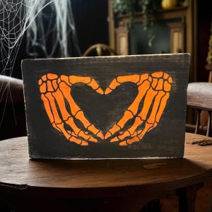 Halloween Skull Hand Heart Wood Sign: Spooky Decor