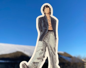 May include: A sticker of a person wearing a blue blazer, light blue pants, and a silver necklace. The person is walking and their face is not visible.