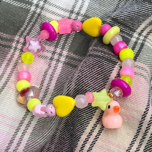 Pulsera de pato decorativa amarilla y rosa