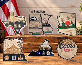 May include: Six custom wooden plaques shaped like US states and a bottle cap, featuring laser-engraved military insignia, text, and graphic illustrations. The designs include state outlines, desert landscapes, and military rank emblems.