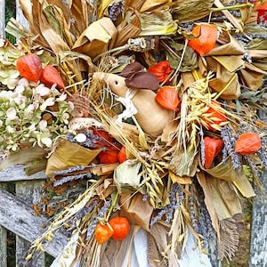 Natural autumn wreath with a field mouse