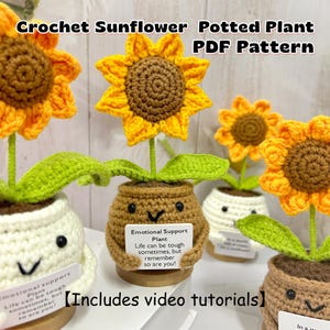 May include: Crocheted sunflower potted plants with yellow petals and brown centers. The plants are in small pots with smiling faces and a tag that reads "Emotional Support Plant." The text "Crochet Sunflower Potted Plant PDF Pattern" is at the top.