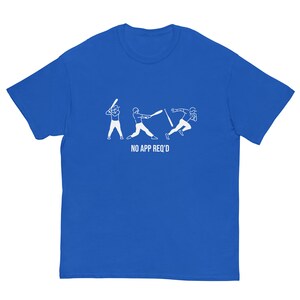 May include: A royal blue t-shirt featuring a white graphic of three baseball players. The text "NO APP REQ'D" is printed below the graphic.