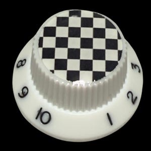 May include: A white circular control knob with a ribbed side edge and a black and white checkered pattern on the top surface. The sloped outer edge features black printed numbers ranging from one to ten, indicating a graduated scale for adjustment.