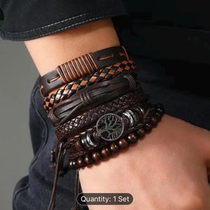 May include: A set of five leather bracelets with a tree of life charm and wooden beads. The bracelets are brown and black with a woven design. Quantity: 1 Set