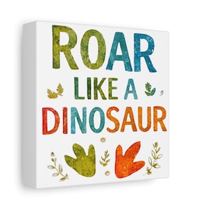 May include: A square canvas print with the words "ROAR LIKE A DINOSAUR" in colorful watercolor lettering. The print features dinosaur footprints and leaf accents, perfect for a child's room or nursery.