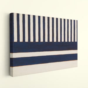 May include: A rectangular canvas wall art piece featuring a geometric pattern. The top section displays vertical navy blue and white stripes, while the bottom section consists of two horizontal navy blue bands separated by white stripes.
