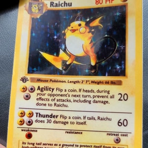 May include: A Raichu Pokémon trading card. The card features a yellow and orange Raichu illustration with the text "Raichu" and "80 HP". The card also includes text about the character's abilities and stats. The card measures 2' 7" in length and weighs 66 lbs.