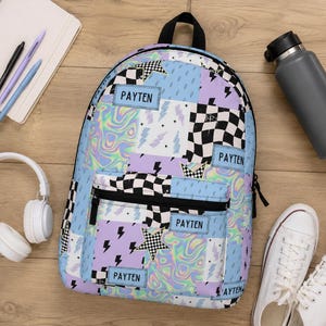 Pastel checkered backpack featuring a customizable name and modern colorful design. Durable everyday bag perfect for school, travel, sleepovers, and extracurricular activities. Comfortable backpack for kids and teens who love trendy, personalized accessories.