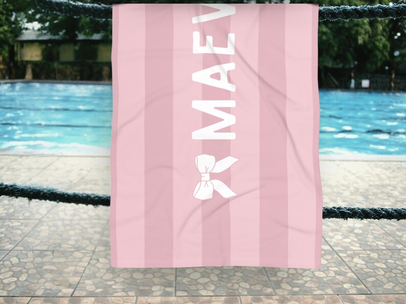 This custom coquette bow beach towel is the perfect blend of style and function for kids and teens. Designed with a personalized name and trendy bow detail, this custom pool towel makes a great vacation towel gift or summer accessory. Soft and absorbent, it’s ideal for beach days, poolside lounging, and travel, making it a fun and unique gift idea for girls!
