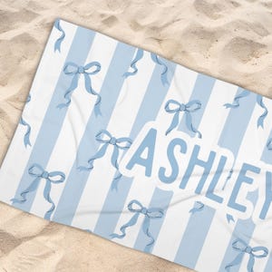 Custom name coquette bow beach towel in a stylish design, perfect for girls, teens, and kids. A personalized pool towel ideal for spring break, vacations, and bachelorette gifts. This trendy custom color towel makes a great gift idea for any occasion.