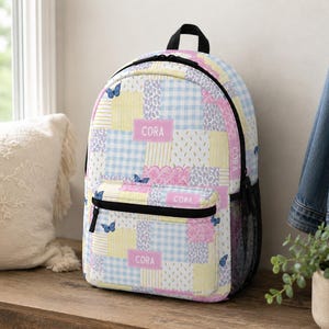 Patchwork style backpack featuring soft pastel patterns and customizable name detail. Durable everyday bag perfect for school, travel, sleepovers, and daily adventures. Trendy design for kids and teens who love colorful, feminine, vintage inspired accessories.