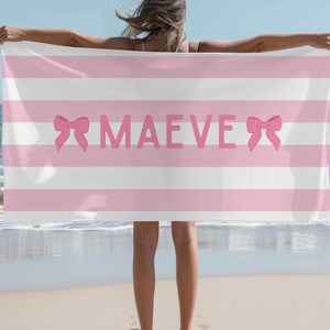 This custom coquette bow beach towel is the perfect blend of style and function for kids and teens. Designed with a personalized name and trendy bow detail, this custom pool towel makes a great vacation towel gift or summer accessory. Soft and absorbent, it’s ideal for beach days, poolside lounging, and travel, making it a fun and unique gift idea for girls!