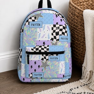 Pastel checkered backpack featuring a customizable name and modern colorful design. Durable everyday bag perfect for school, travel, sleepovers, and extracurricular activities. Comfortable backpack for kids and teens who love trendy, personalized accessories.