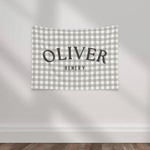 May include: A gray and white gingham tapestry with the text "OLIVER HENERY" in black.