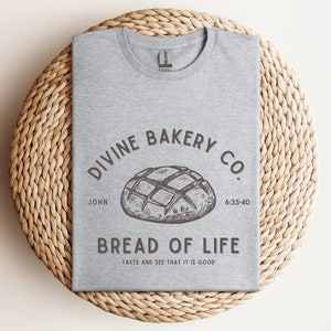 Faith-based sourdough t-shirt with a Bible verse, perfect for a birthday gift for her or a sourdough-themed gift for a friend. This Christian baking shirt is a great sourdough gift for bread lovers who enjoy faith-inspired apparel and scripture-based designs.