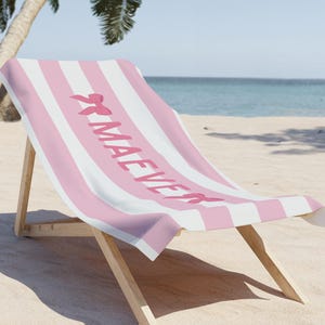 This custom coquette bow beach towel is the perfect blend of style and function for kids and teens. Designed with a personalized name and trendy bow detail, this custom pool towel makes a great vacation towel gift or summer accessory. Soft and absorbent, it’s ideal for beach days, poolside lounging, and travel, making it a fun and unique gift idea for girls!
