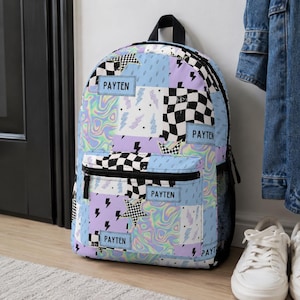 Pastel checkered backpack featuring a customizable name and modern colorful design. Durable everyday bag perfect for school, travel, sleepovers, and extracurricular activities. Comfortable backpack for kids and teens who love trendy, personalized accessories.