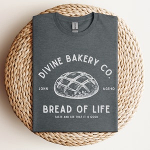 Faith-based sourdough t-shirt with a Bible verse, perfect for a birthday gift for her or a sourdough-themed gift for a friend. This Christian baking shirt is a great sourdough gift for bread lovers who enjoy faith-inspired apparel and scripture-based designs.
