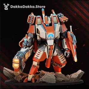 May include: A painted miniature robot figure featuring orange and cream armor plating, blue glowing accents, and a large weapon on its right arm. The text DakkaDakka.Store is visible in the upper left corner above the mechanical character.