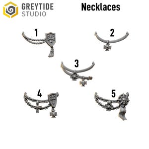 May include: An image showcases five gray necklaces with various pendant designs. The necklaces are numbered 1 through 5. The pendants include shields, crosses, and skulls. The text "Necklaces" is displayed at the top of the image.