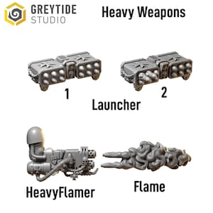 May include: Image of GreyTide Studio's Heavy Weapons, including two Launcher models and a HeavyFlamer with a Flame effect. The launchers are rectangular with multiple missile barrels. The HeavyFlamer has a detailed design with a skull emblem.