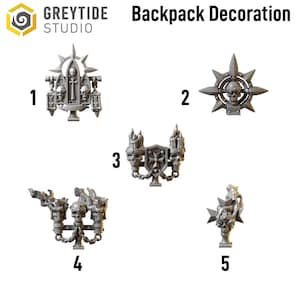 May include: A collection of five gray backpack decorations. Each decoration features gothic and skull motifs. The decorations include crosses, candles, and starburst designs. The text "Backpack Decoration" is visible.
