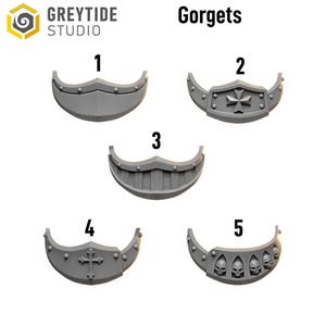May include: A collection of five gray gorgets, each with a unique design. The gorgets are numbered 1 through 5. The text "Gorget" is displayed above the gorgets. The Greytide Studio logo is in the upper left corner.