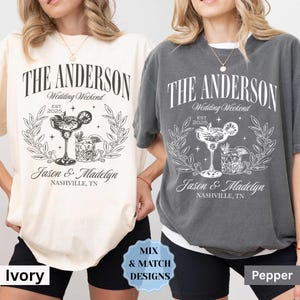 May include: Two t-shirts with a graphic design featuring a cocktail glass with a lime wedge and the text "The Anderson Wedding Weekend Est. 2025 Jason & Madelyn Nashville, TN". The t-shirts are in ivory and pepper colors.