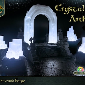 May include: A white crystal archway with glowing lights, surrounded by smaller crystal structures. The archway is part of a miniature fantasy landscape, with a stone path leading through it. The text "Crystal Arch" is written in gold lettering above the archway. The text "Emberwood Forge" is written in green lettering at the bottom of the image. The text "12 LED Colors" is written in white lettering on a rainbow circle.
