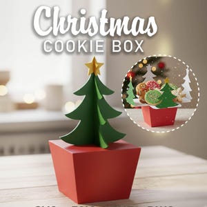 May include: A red Christmas cookie box with a green tree and gold star topper. The words "Christmas COOKIE BOX" are at the top. A smaller image shows cookies in a red box. The bottom of the image has the words "SVG - PNG - DXF - DWG".