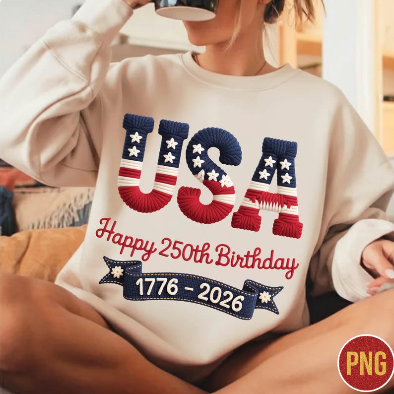 May include: Cream-colored sweatshirt with the word "USA" in red, white, and blue, with stars and stripes design. Below, the text reads "Happy 250th Birthday 1776-2026" on a blue banner. The sweatshirt celebrates the USA's anniversary.
