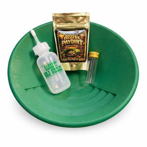 May include: A green plastic gold pan with a white squeeze bottle, a small glass vial, and a gold foil pouch. The squeeze bottle has the text "GARRETT GOLD GUZZLER" printed on it. The gold foil pouch has the text "MIDWEST DIGGERS PAYDIRT Strike it Rich!" printed on it.