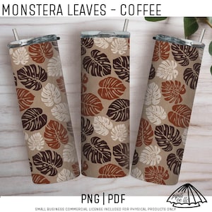 May include: Three stainless steel tumblers with lids and straws. The tumblers feature a repeating pattern of monstera leaves in shades of brown, white, and dark brown on a tan background. The text "MONSTERA LEAVES - COFFEE" is at the top.