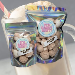 May include: Two small bags of candy shaped like root beer floats. The bags are iridescent and have a sticker that says "It's Candy Baby!" and "Root Beer Float".