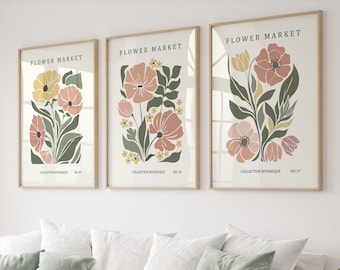 May include: Three framed prints with floral illustrations. Each print features a different arrangement of flowers in shades of pink, yellow, and green. The prints are titled "FLOWER MARKET" and include the text "COLLECTION BOTANIQUE" and a number.
