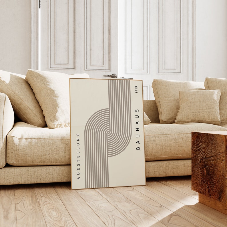May include: A beige and brown minimalist poster with the text "AUSSTELLUNG BAUHAUS 1919" and a geometric design of curved lines.