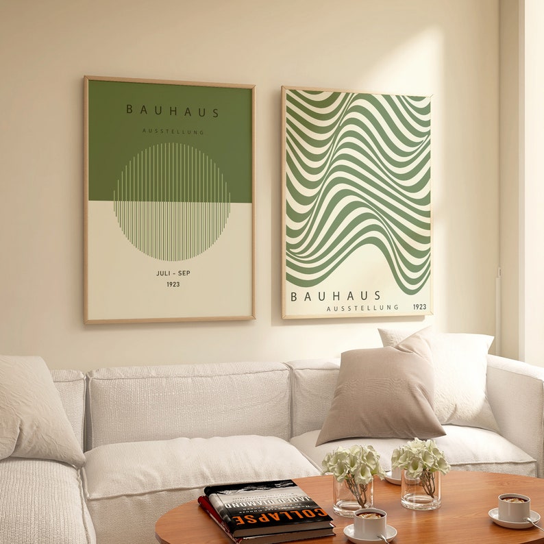 May include: Two framed prints with a green and white color scheme. The print on the left has the text "BAUHAUS AUSSTELLUNG JULI - SEP 1923" and features a green circle with white vertical lines. The print on the right has the text "BAUHAUS AUSSTELLUNG 1923" and features a green and white abstract design with wavy lines.